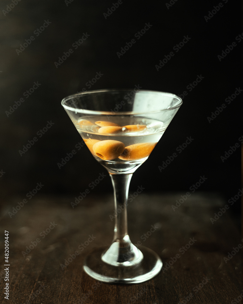 Martini with olives in an original cocktail glass.