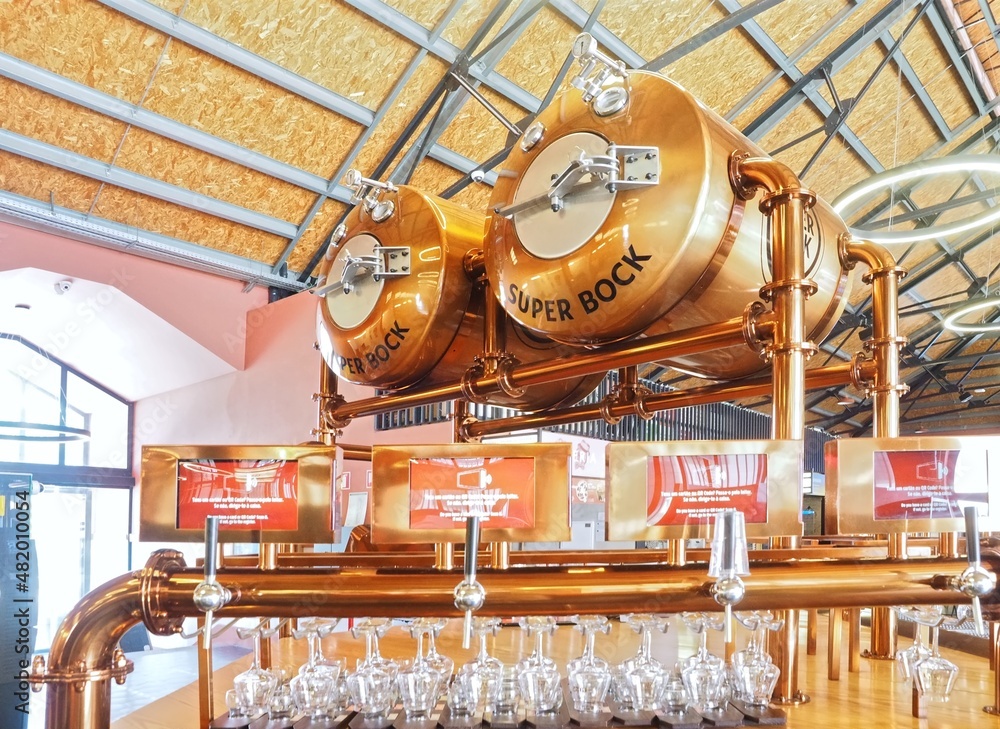 Copper Super Bock beer dispenser with glasses in Porto Stock Photo