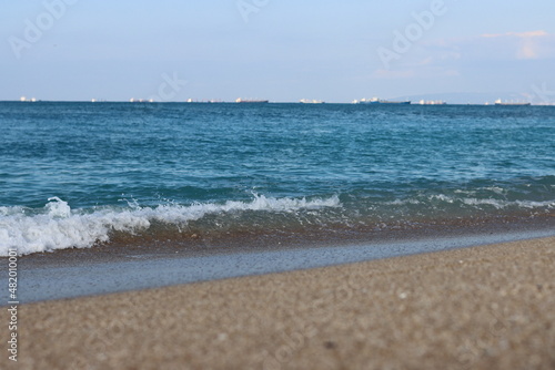 Empty beach photo. Beautiful coastline with calm seawater  sand  no people. 