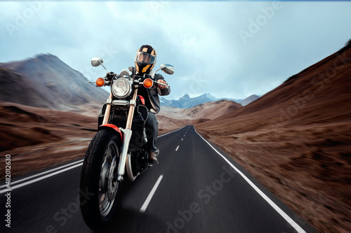 Man seat on the motorcycle on the desert road