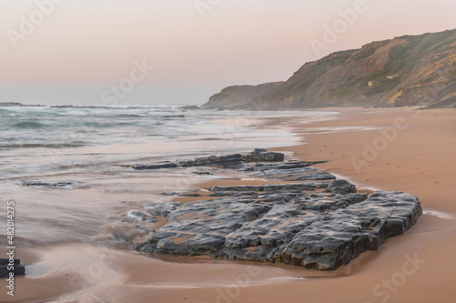 Movement of the waves at sunset in the Carreagem Beach. Aljezur. Algarve