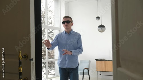 Blind man cautiously moving towards the exit in the apartment