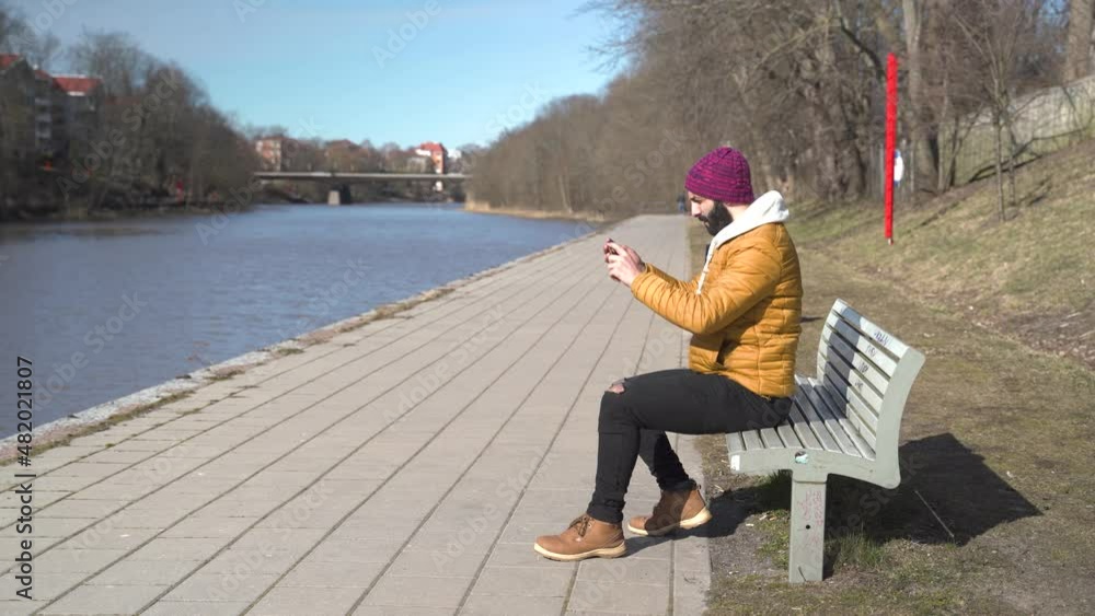 Young man filming with his cellphone in Finland. Young man filming with his cellphone in Finland.