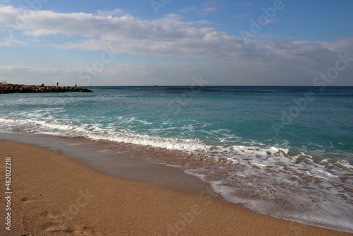 Empty beach photo. Beautiful coastline with calm seawater  sand  no people. 