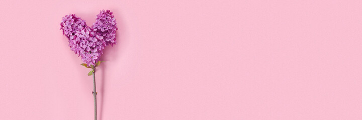 Valentine's Day card with bouquet of lilacs on paper background. Symbolic heart.