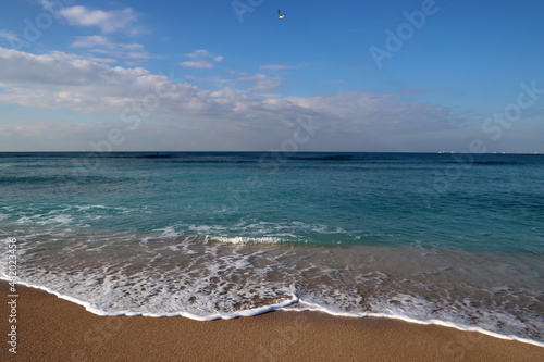 Clear blue sea water close up photo. Calm sea  blue sky   tranquil scene. Warm day on the beach. 
