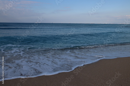 Clear blue sea water close up photo. Calm sea, blue sky, tranquil scene. Warm day on the beach. 