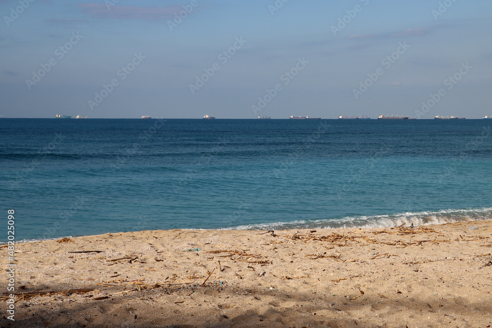 Empty beach photo. Beautiful coastline with calm seawater, sand, no people. 