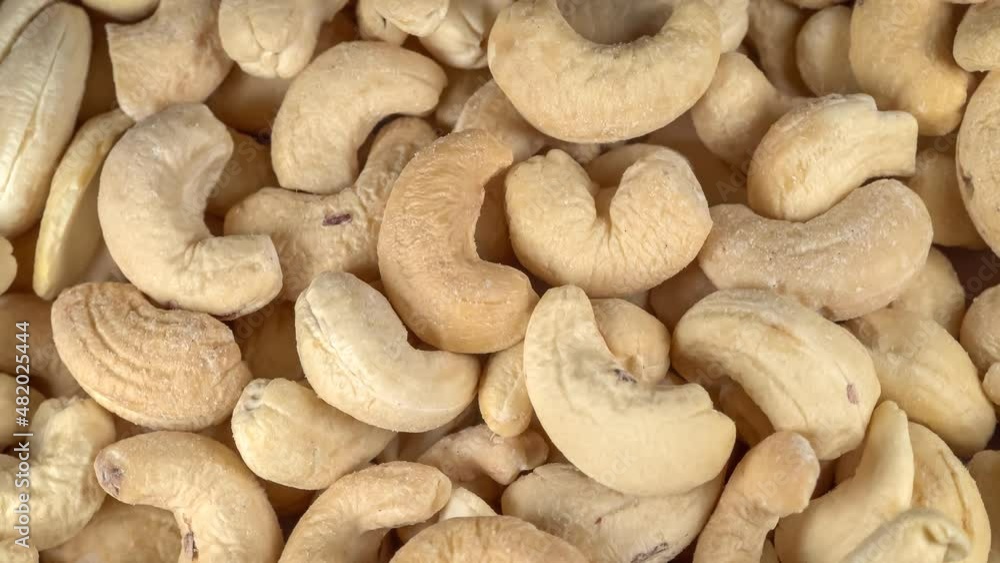 Many cashew nuts at rotating background - looping video Many cashew nuts at rotating background - looping video