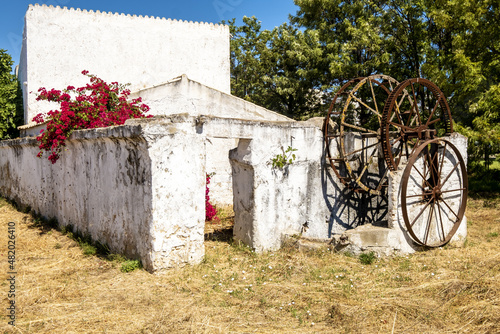 rusty cogs of an old well in faro, algarve, portugal