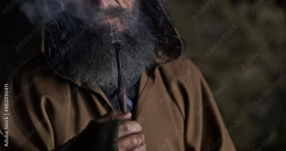 Bearded male hermit smoking pipe Bearded male hermit smoking pipe