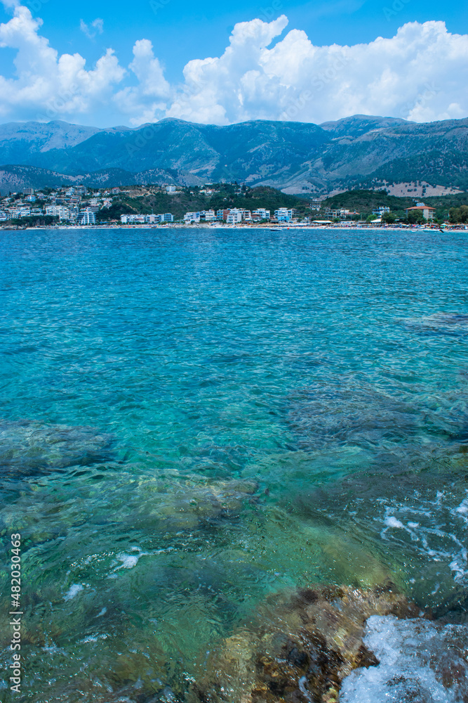 Beautiful summer cloud landscape of beach town of Himare. Adriatic sea. Albania. Concept of summer holidays and relaxation.