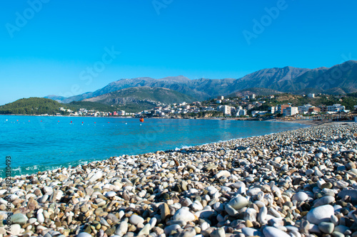Beautiful summer cloud landscape of beach town of Himare. Adriatic sea. Albania. Concept of summer holidays and relaxation.