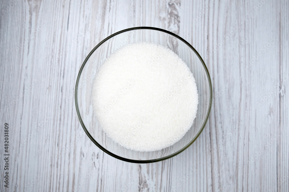 sugar in a transparent bowl. sugar on the table sugar in a transparent bowl. sugar on the table
