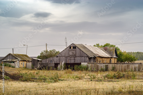 Rural house with outbuildings on the edge of the village. Russia, Orenburg region, farm Arapovka