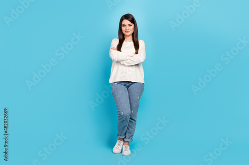 Full length photo of young pretty woman crossed hands standing smart isolated over blue color background