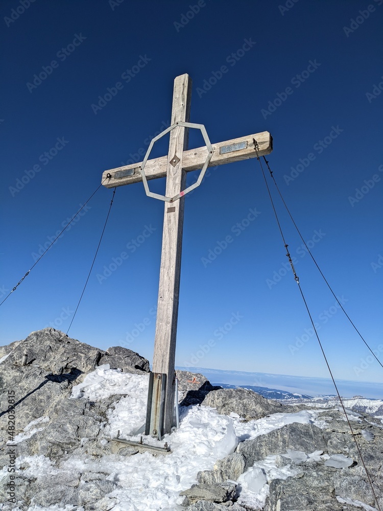 Fototapeta premium Summit cross on the Clariden summit. Ski touring in winter. The Clariden is a 3267m . Mountain of the Glarner Alps swiss