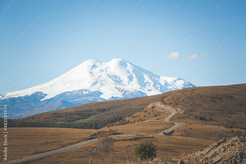 picturesque beautiful view of Elbrus, green fields and beautiful natural nature of the Caucasian mountains, the concept of travel in Russia.