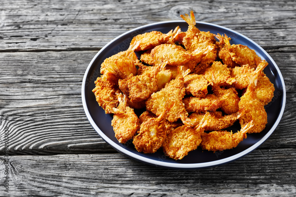 Crispy Fried Butterfly Shrimp on a grey plate Crispy Fried Butterfly Shrimp on a grey plate