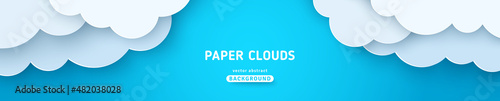 Beautiful fluffy clouds on blue sky background. Vector illustration. Paper cut style. Place for text. Summer day paperart long banner header. Spring morning, cartoon cumulus, drawing