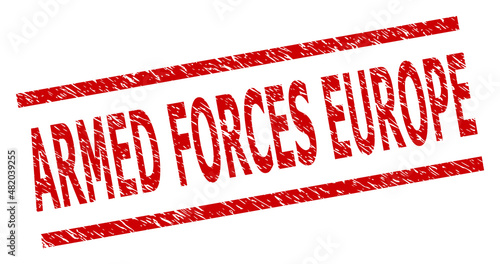 Red ARMED FORCES EUROPE stamp. ARMED FORCES EUROPE stamp with parallel line elements. Rough ARMED FORCES EUROPE stamp in red color, with unclean texture.