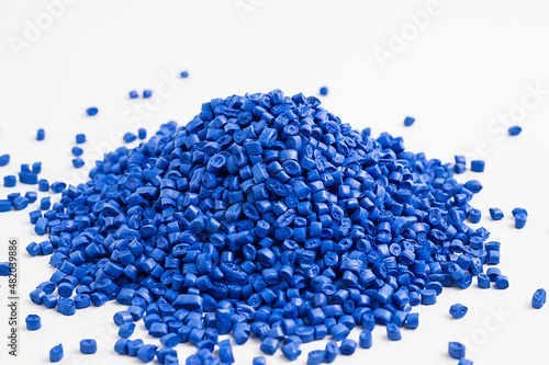 blue granules of polypropylene, polyamide. White background. Plastic and polymer industry. Microplastic products.	