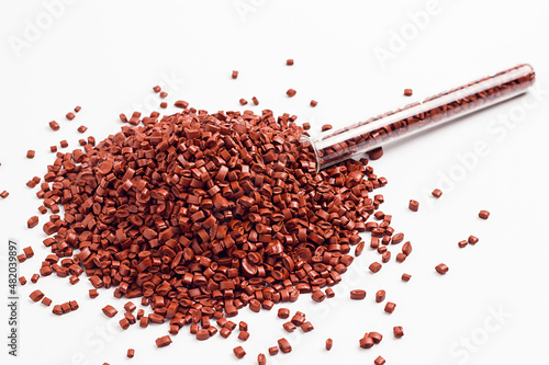brown granules of polypropylene, polyamide. White background. Plastic and polymer industry. Microplastic products.