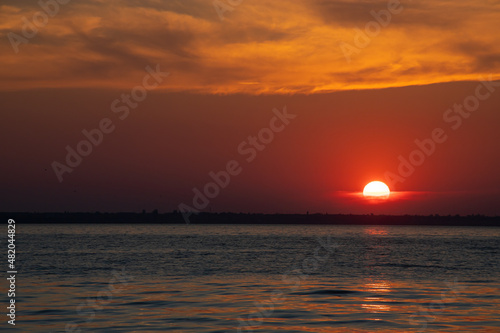 Beautiful red and orang sunset over the lake © Oleh Marchak