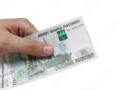 One thousand Russian rubles in the male right hand on a white background