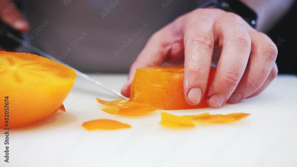 cutting persimmons with a table knife cutting persimmons with a table knife