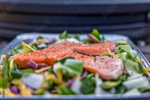 Aluminium griddle plate with salmon and mix of vegetables photo