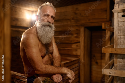 Grey-haired senior man rest at bath house