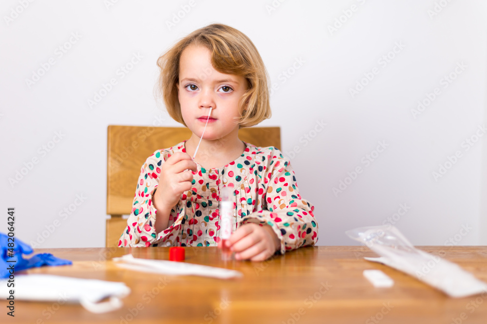 Cute blonde girl self testing for corona virus and waiting for results. Cute blonde girl self testing for corona virus and waiting for results.