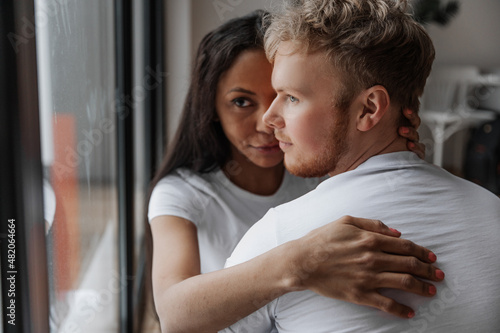 Affectionate lovely multiracial couple embracing with fondness