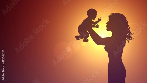 Silhouette of a mother holding a baby against the background of the and sunset sky