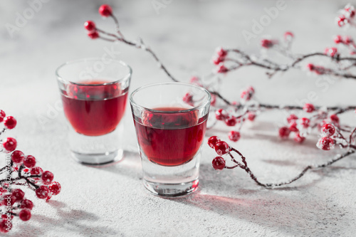 Two glasses of cherry liqueur on white background. Christmas or new year party celebration concept. Winter holidays concept.
