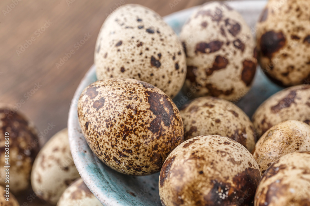 Quail eggs on the wooden plate. Quail eggs can be consumed by frying or boiling. In Indonesia quail eggs called telur puyuh. Quail eggs on the wooden plate. Quail eggs can be consumed by frying or boiling. In Indonesia quail eggs called telur puyuh.