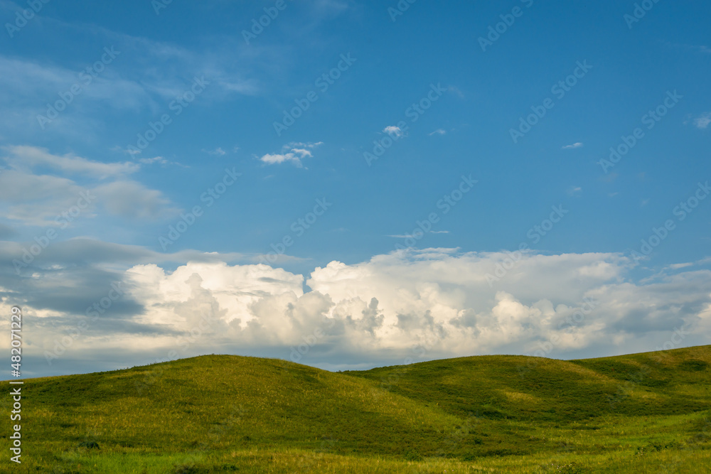Green field and hills with blue sky. Green field and hills with blue sky.