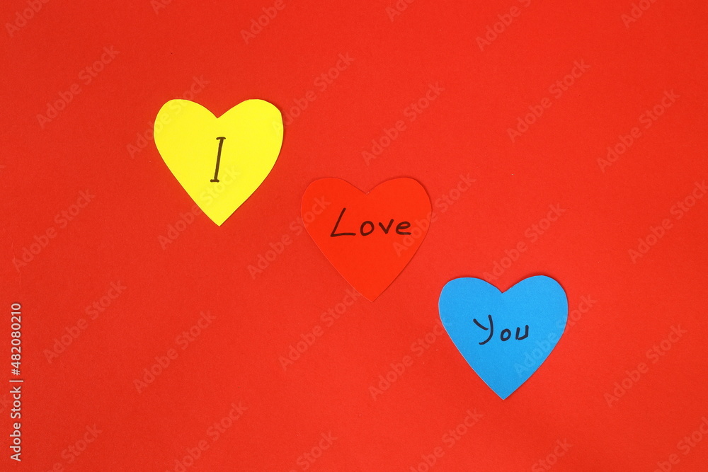 Valentines Day hearts on vintage red background as Valentines Day symbol. Heart shaped note papers with 