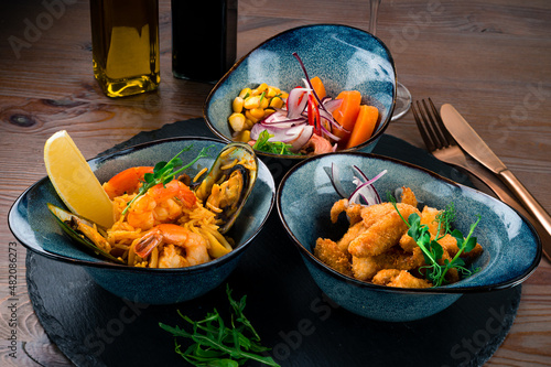 three-course set of salmon ceviche, seafood rice and fish chicharones photo