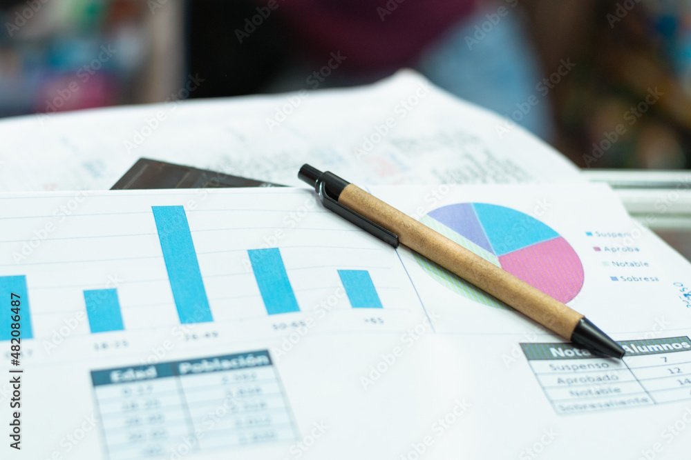 eco-friendly cardboard pencil. on top of a sales chart, abandoned due to poor financial status. declining balance sheet. concept of financial failure eco-friendly cardboard pencil. on top of a sales chart, abandoned due to poor financial status. declining balance sheet. concept of financial failure