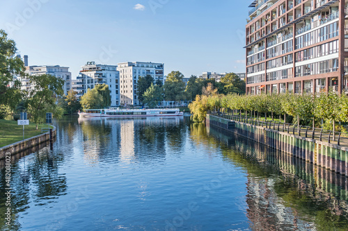  Landwehr Canal with modern residential houses and sightseeing boat Fortuna in Berlin, Germany