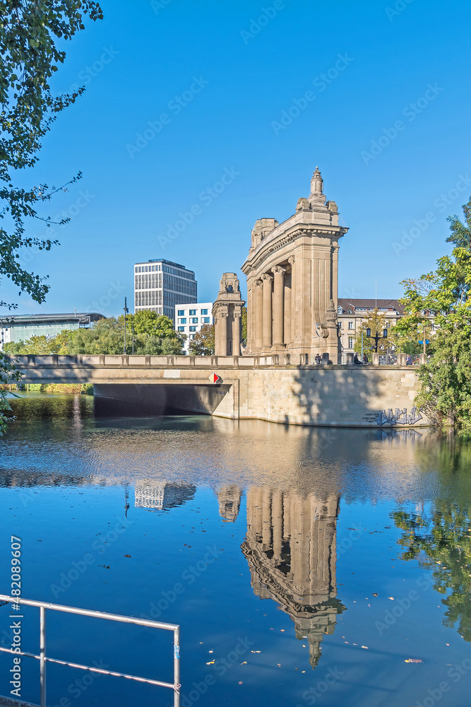 Charlottenburg Bridge reflecting in the water of the Landwehr Canal in Berlin, Germany