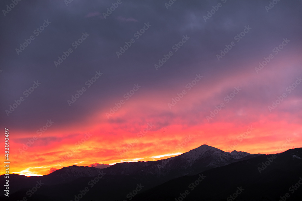 fiery sunset behind the mountains