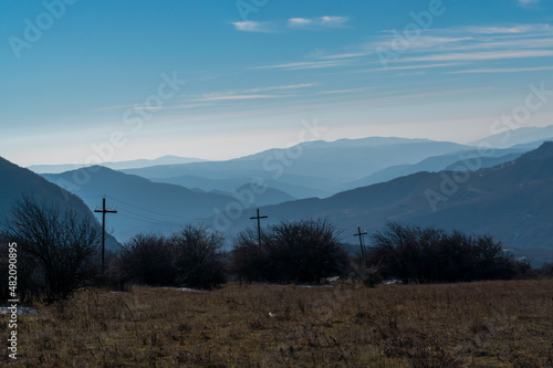 Silhouette of mountain with cross shaped electricity poles. Shamakhi, Azerbaijan. photo