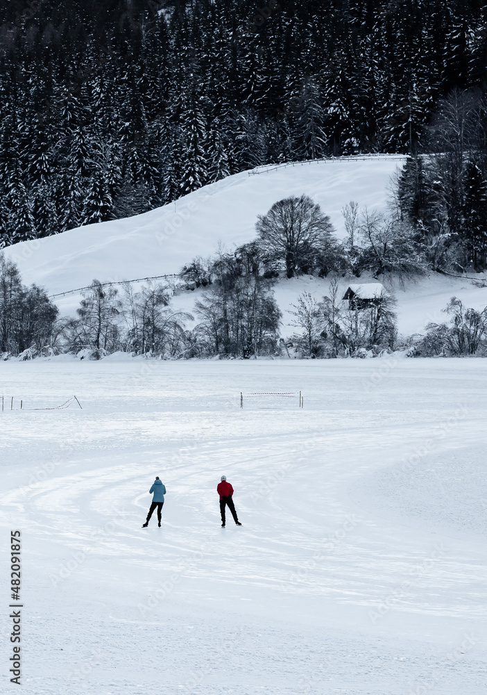 iceskater on frozen alpine lake Weissensee 