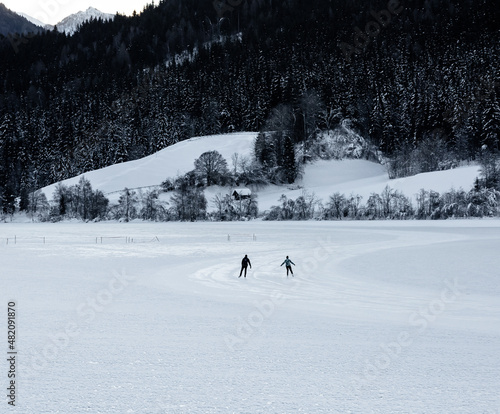 iceskater on frozen alpine lake Weissensee 