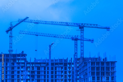 Tower cranes build and development new urban houses architecture industry