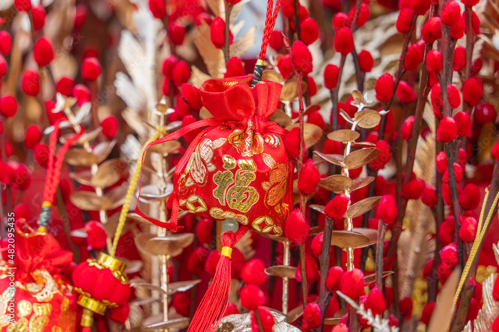 Lucky knot hanging on flower for Chinese new year greeting,Chinese character means good blessing for new year