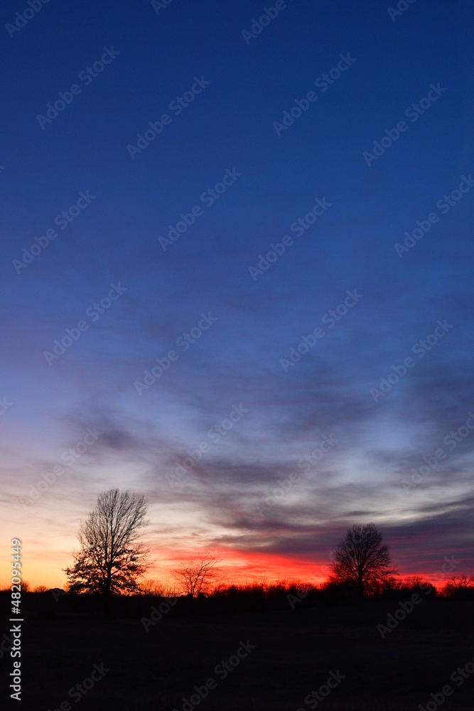 Fototapeta premium Dramatic Sunset Over a Rural Field